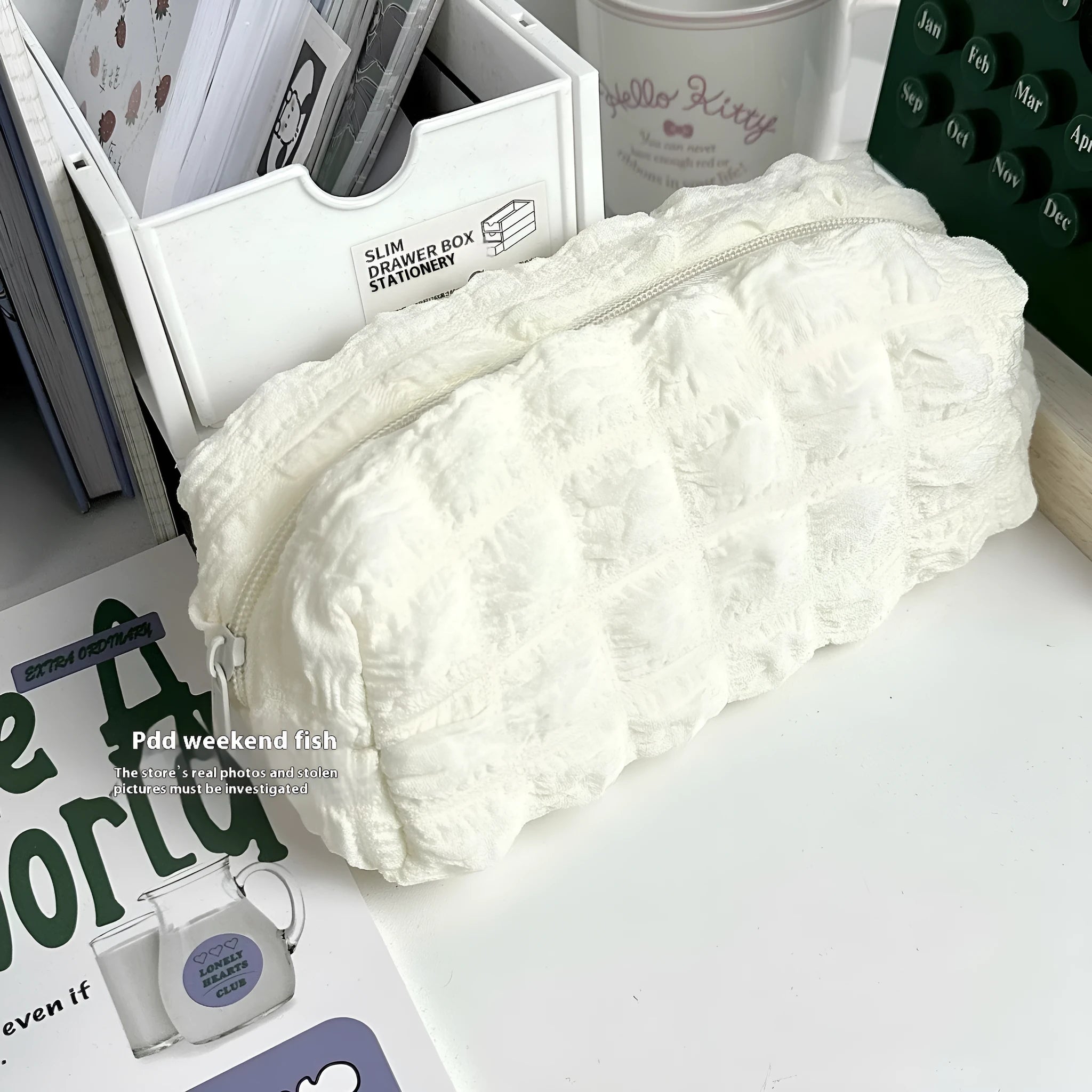 Beige and black fabric pencil cases with cream puff textured design and zipper closure