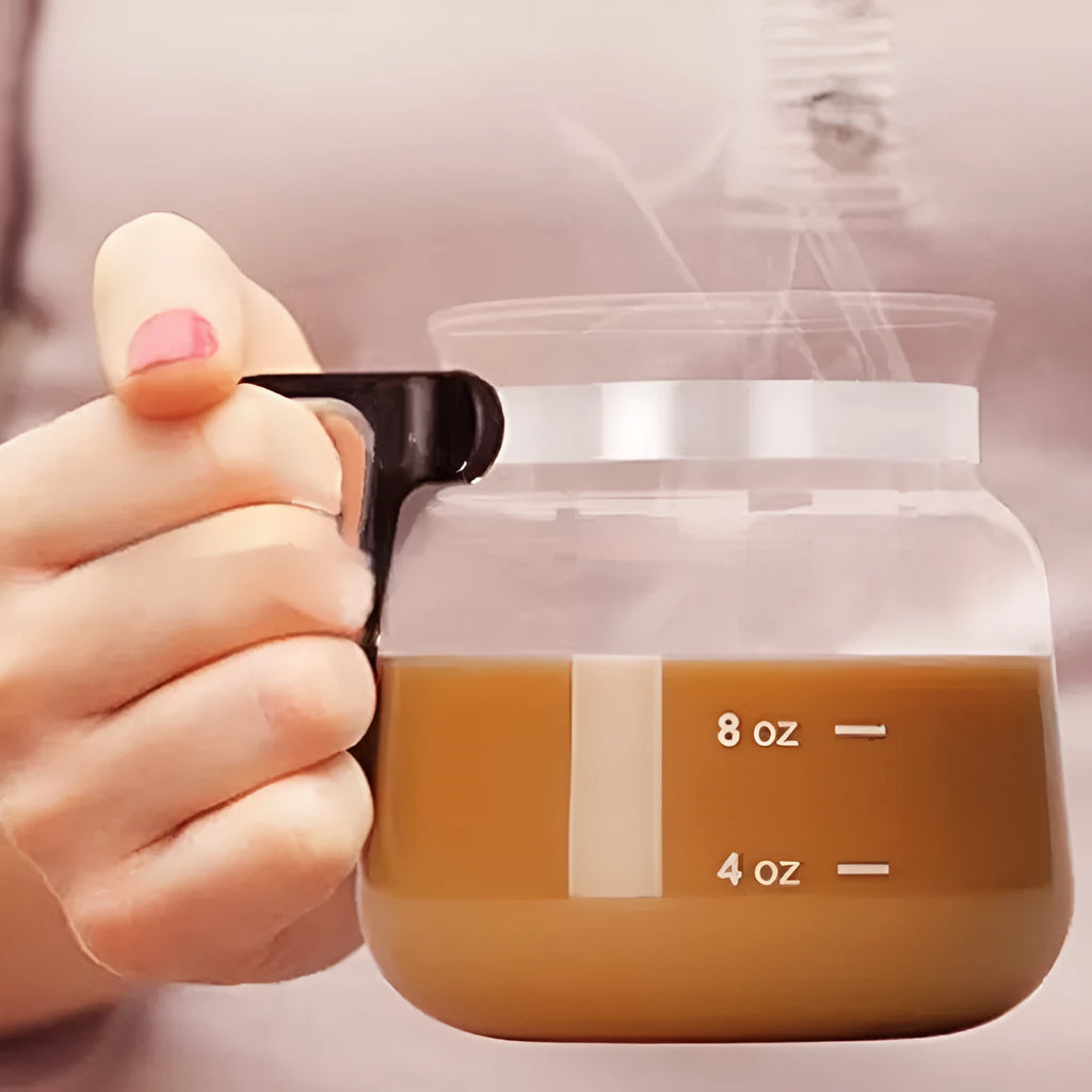 Transparent borosilicate glass coffee maker with a black silicone cover on its neck.