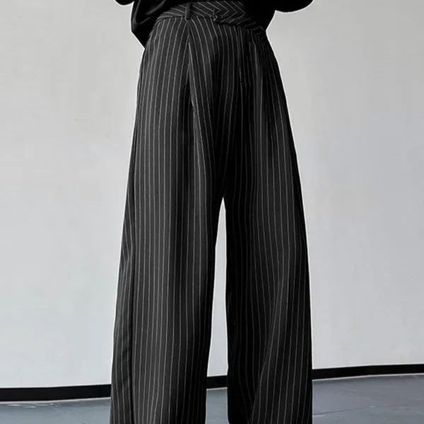 Man wearing black vertical stripe pleated casual trousers.
