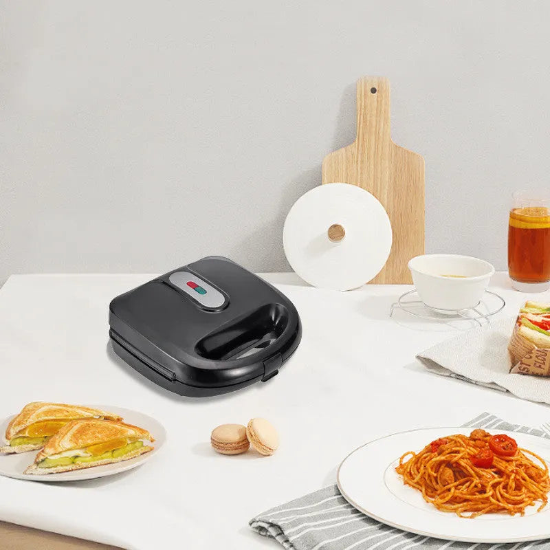 Black double-sided electric sandwich pan with brushed stainless steel lid and non-stick coating.