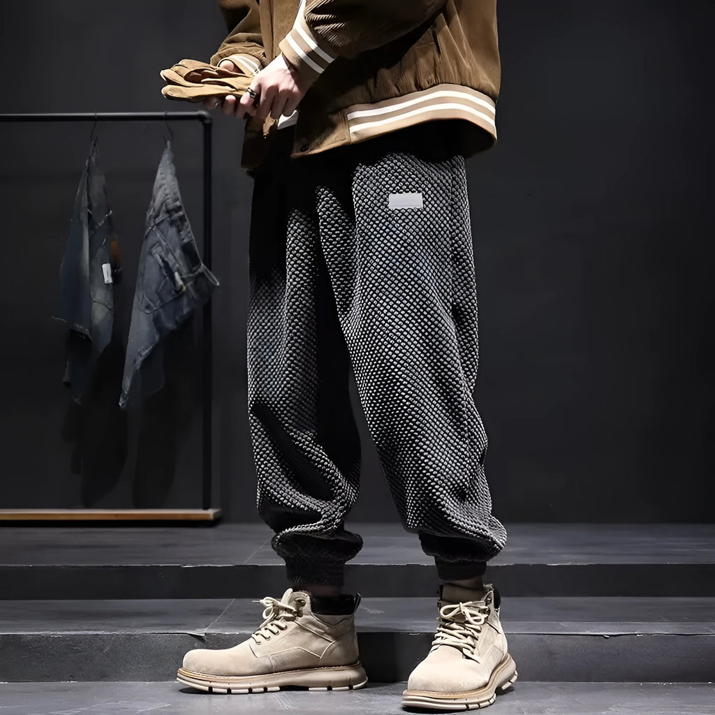 Men's grey straight-leg casual sweatpants with ankle strap detail on a hanger.
