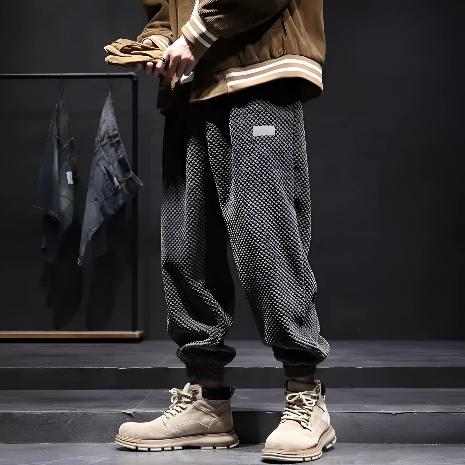 Men's grey straight-leg casual sweatpants with ankle strap detail on a hanger.
