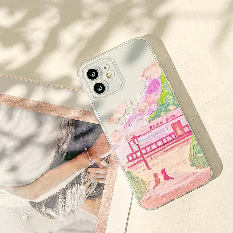 Soft silicone iPhone case with a colourful cartoon graphic of two cats on the back.