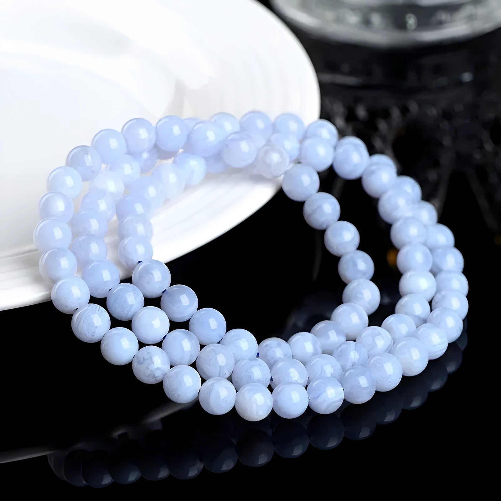 Blue agate bracelet with patterned ball and striped scattered beads showing three-circle construction