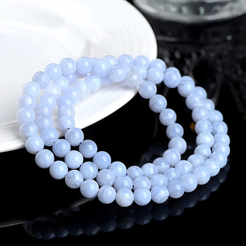 Blue agate bracelet with patterned ball and striped scattered beads showing three-circle construction