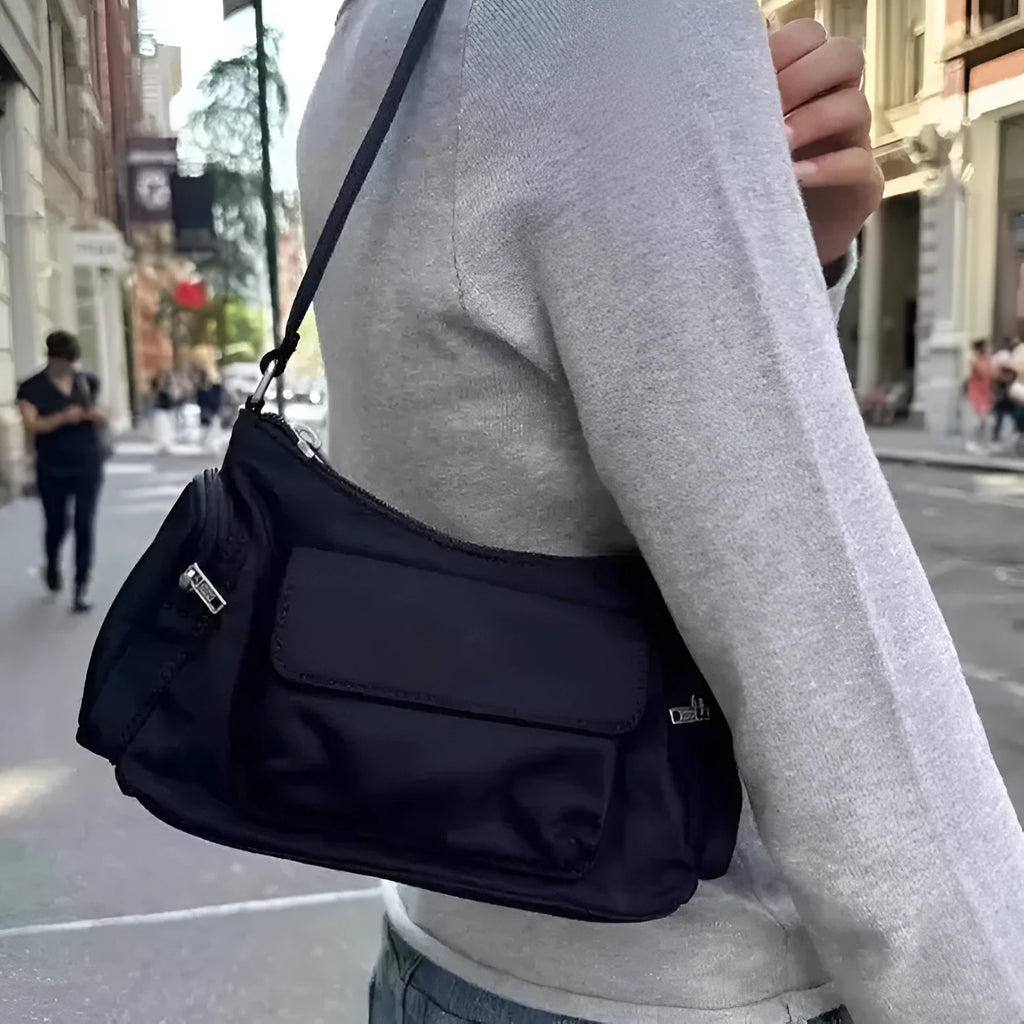 Black PU women's shoulder bag with double pockets showing side line detail, 24cm length