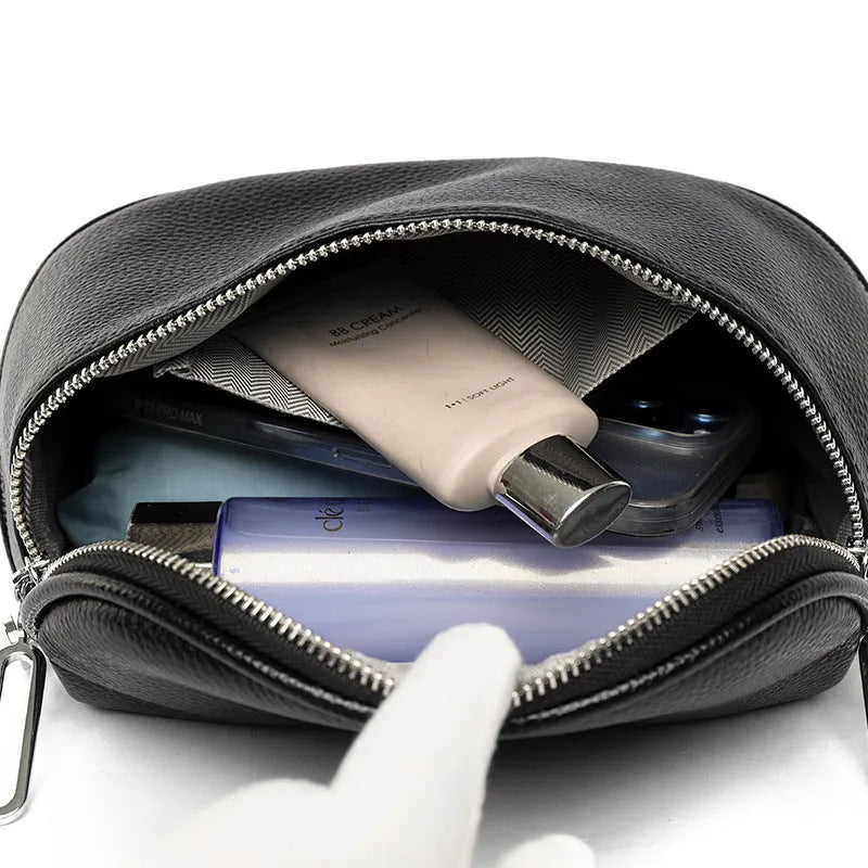 Women's soft black leather saddle-shaped crossbody messenger bag with a zip pocket.