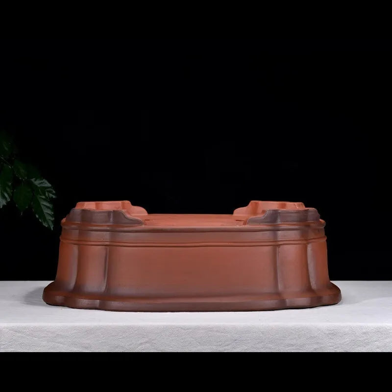 Large antique-finish purple clay flowerpot with raised tree stump and floral design.