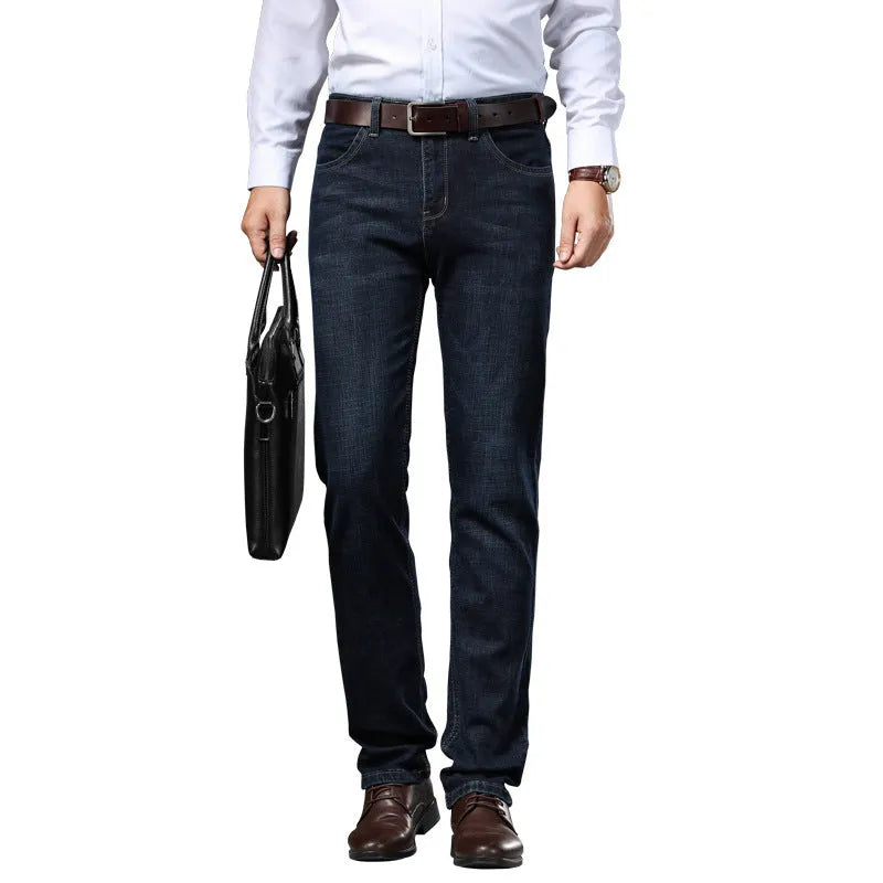 Man wearing straight-leg black stretch denim jeans with a mid waist and zip fly.