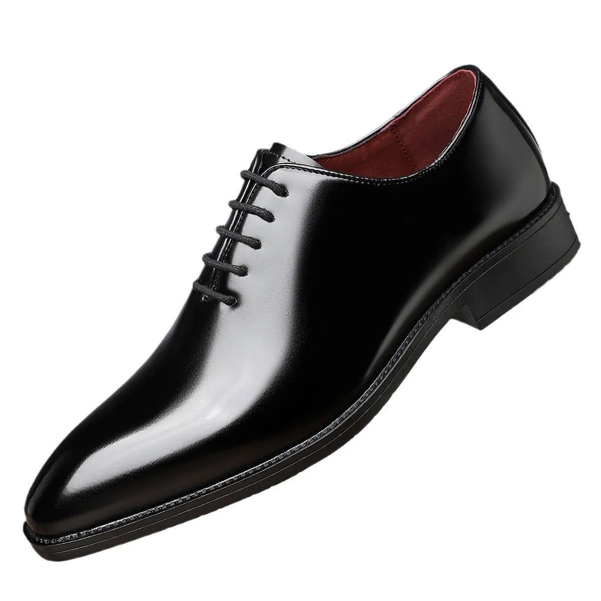 Men's glossy pointed toe business shoes in black with artificial PU upper and rubber sole on a brightly lit surface