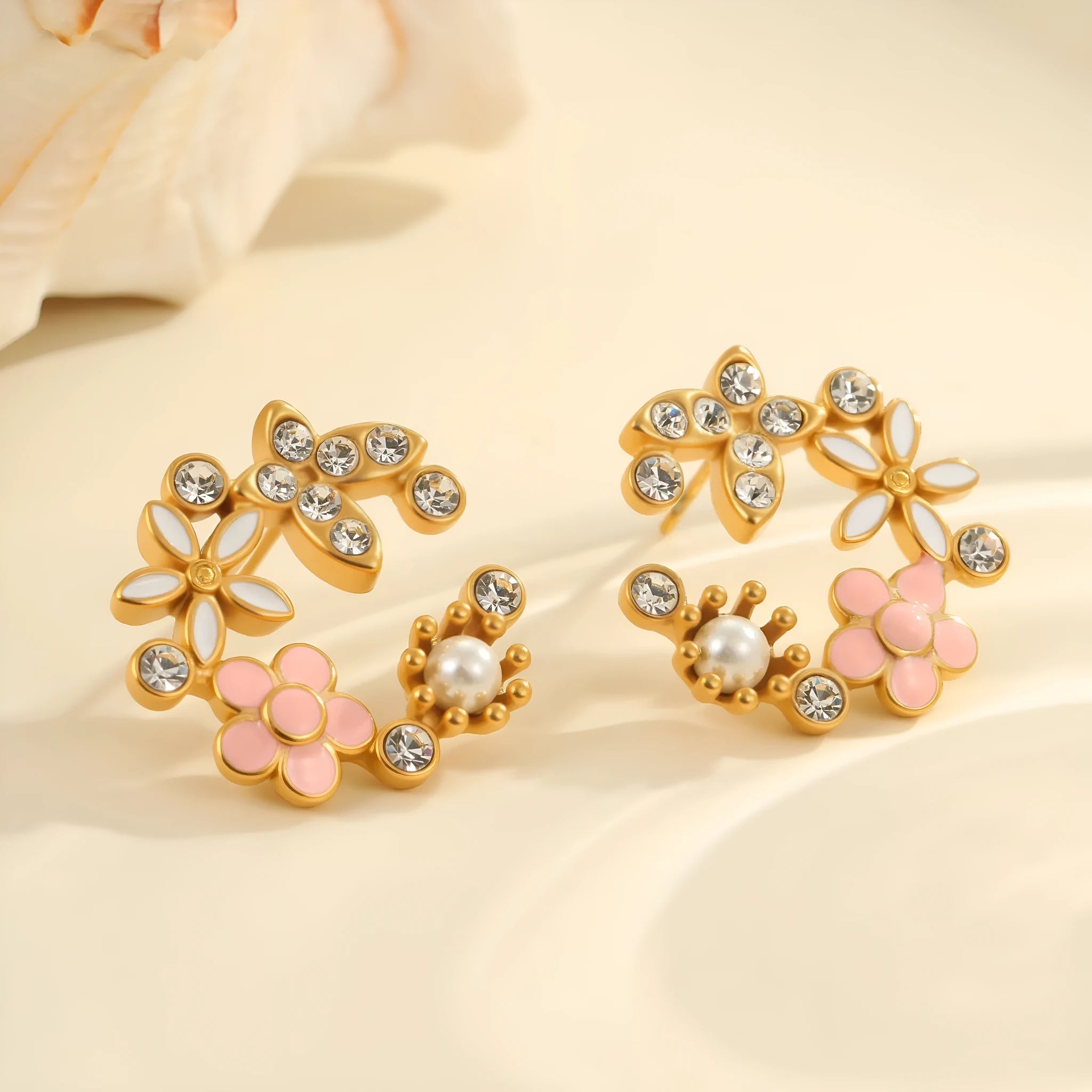 Stainless steel flower stud earrings with colourful oil petals on a white background.