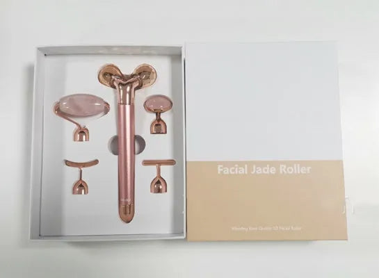 Rose gold five-in-one vibrating face lifting machine with four interchangeable jade and beauty heads in a compact box