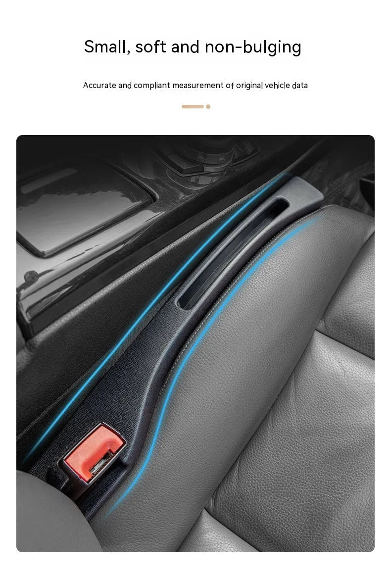 Black plastic car seat gap storage box with handle positioned between vehicle seats