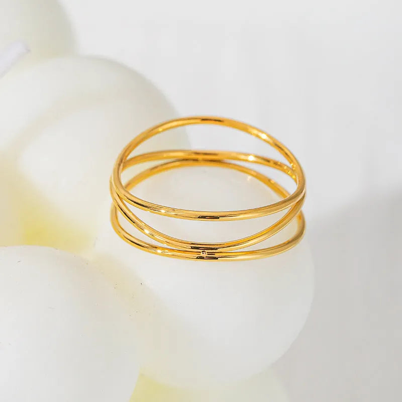Women's geometric line ring with three-layer coil design in gold colour