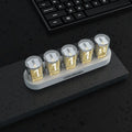 RGB Luminotron LED digital clock in black, white, or wood grain finish showing colourful display on a desk