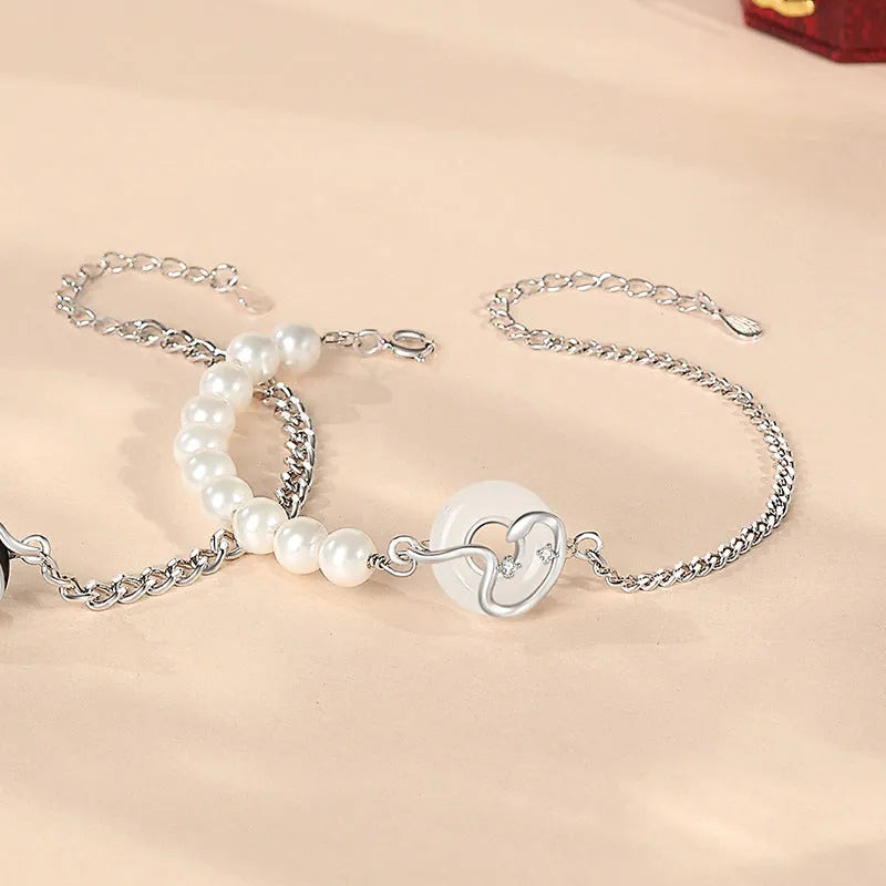 A pair of 925 sterling silver bracelets for men and women featuring a snake zodiac charm and a safety buckle clasp.