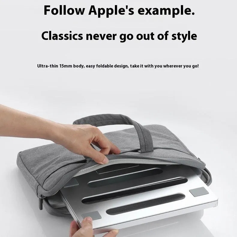 Silver aluminium alloy folding laptop cooling stand on a wooden desk.