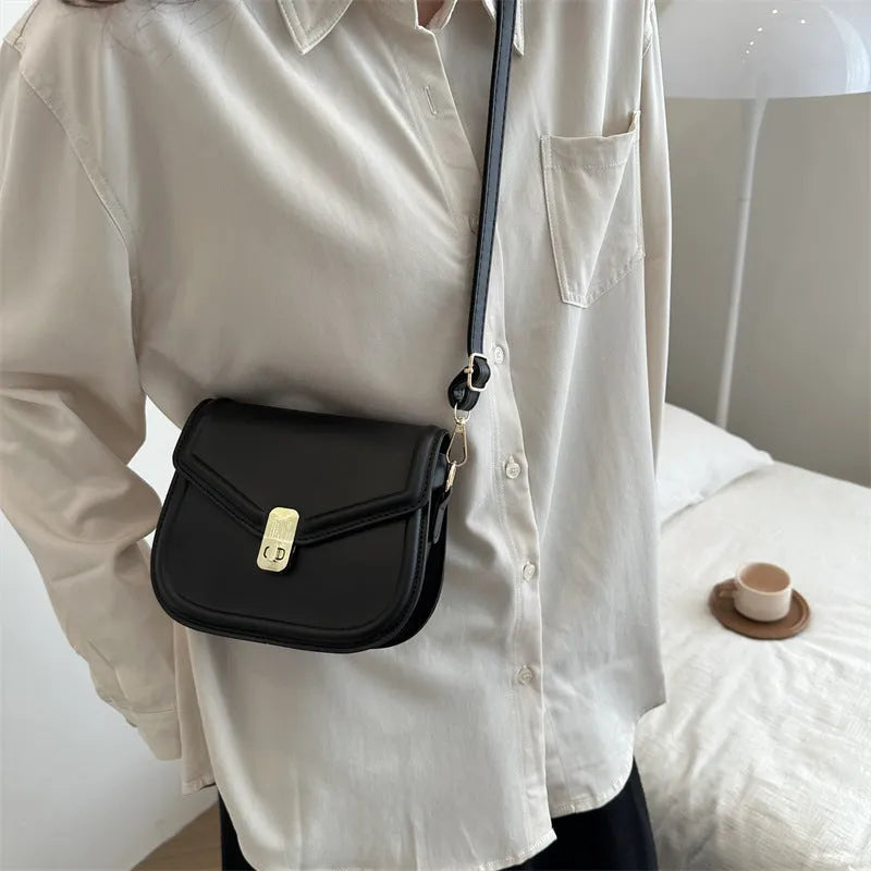 Soft horizontal square messenger bag in clamshell design, shown in black colour.