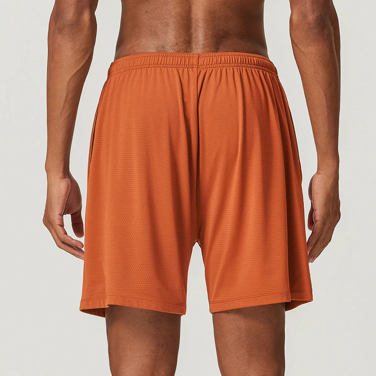 Men's sky green quick-drying running shorts with mid-waist design on a plain background.