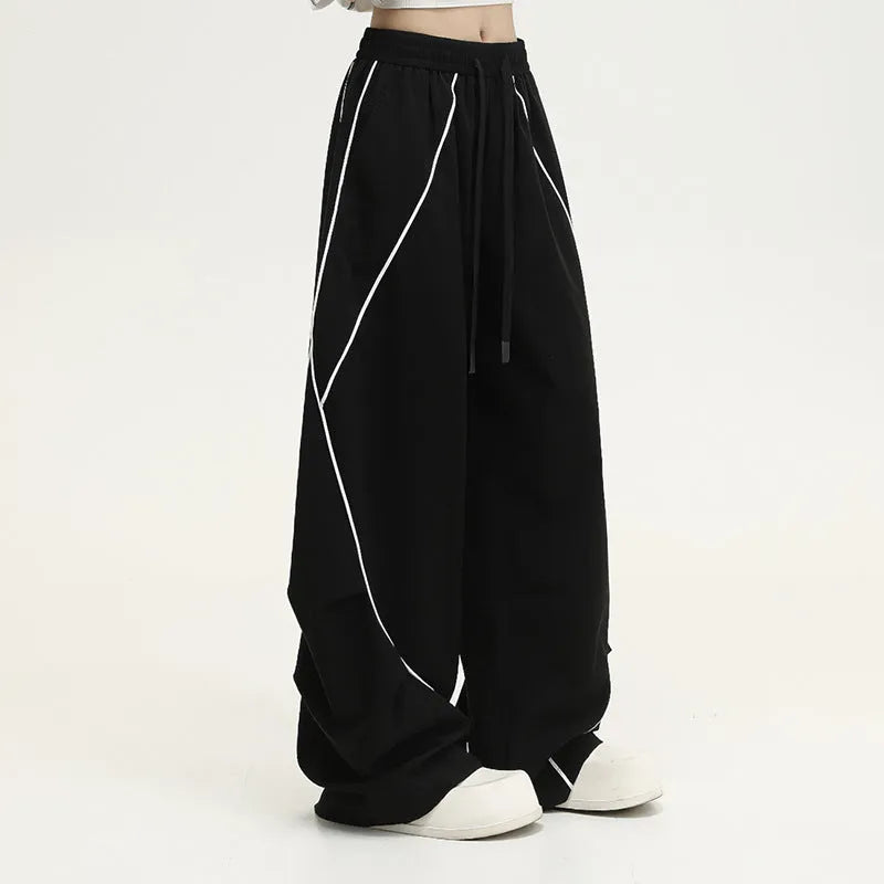 Black pleated wide-leg hip hop sports pants with stripe pattern laid flat