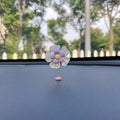 Small colourful plastic car swing decoration for dashboard or mirror.