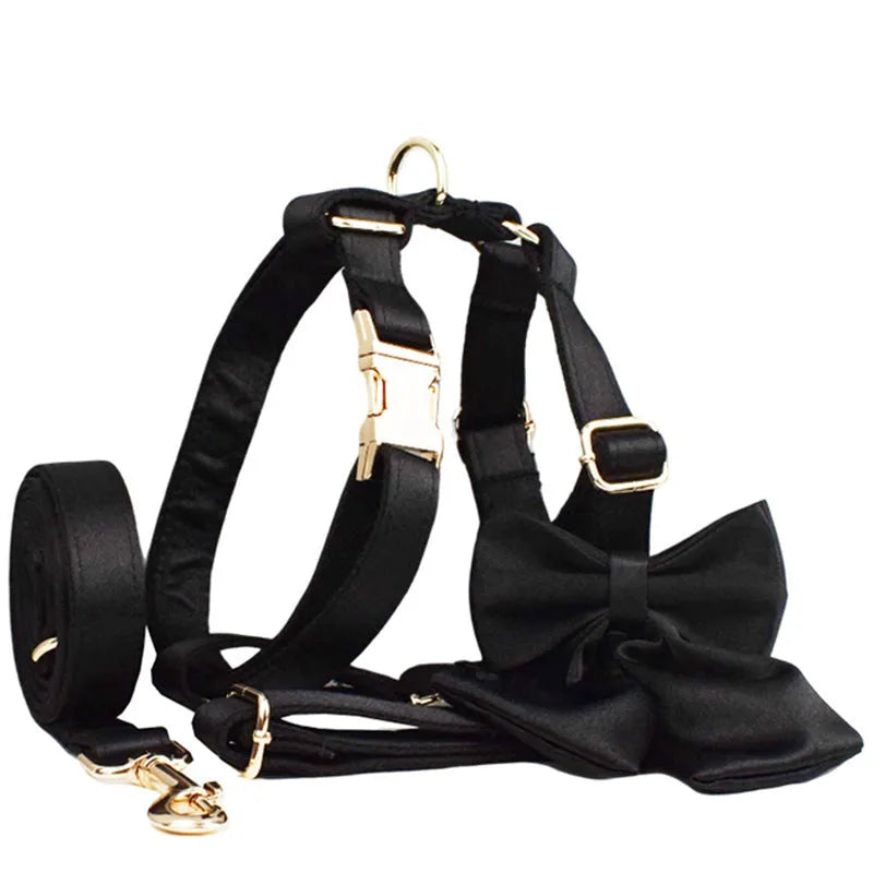 Complete dog accessory set showing collar, leash, bow and vest in cloth material