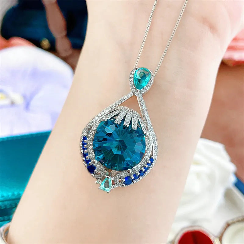 Women's bright blue crystal necklace with geometric fireworks-cut pendant on water wave chain
