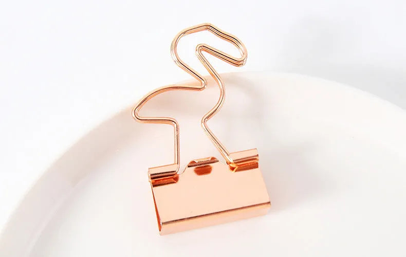Gold-coloured metal office clip in decorative bow shape design