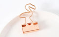 Gold-coloured metal office clip in decorative bow shape design