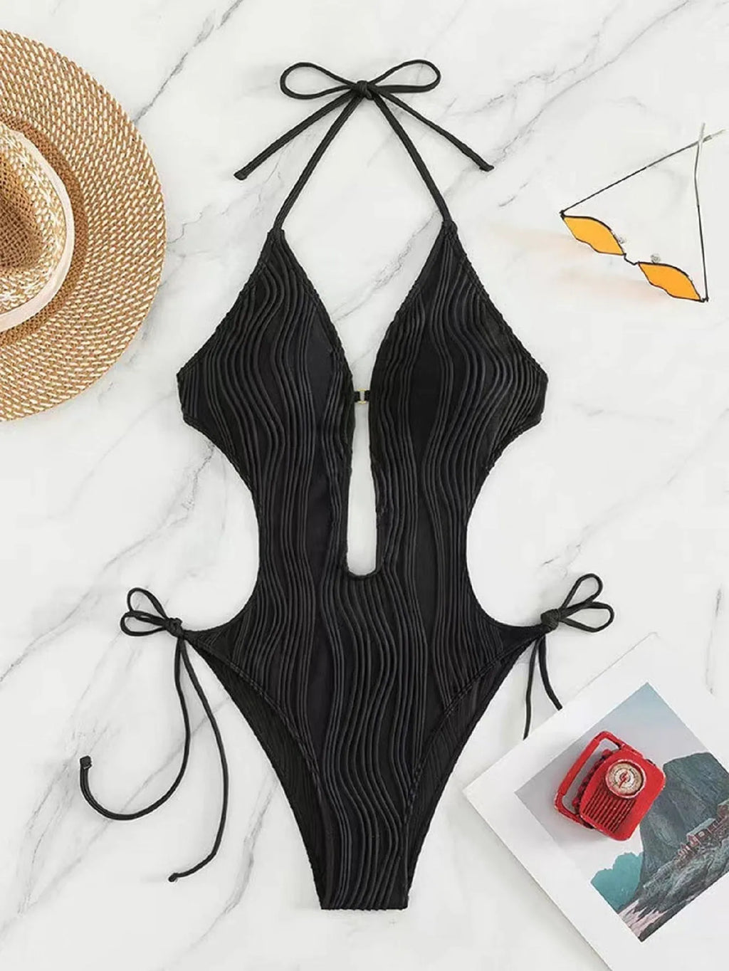 Women's black triangle bikini swimsuit with lace-up front closure on mannequin