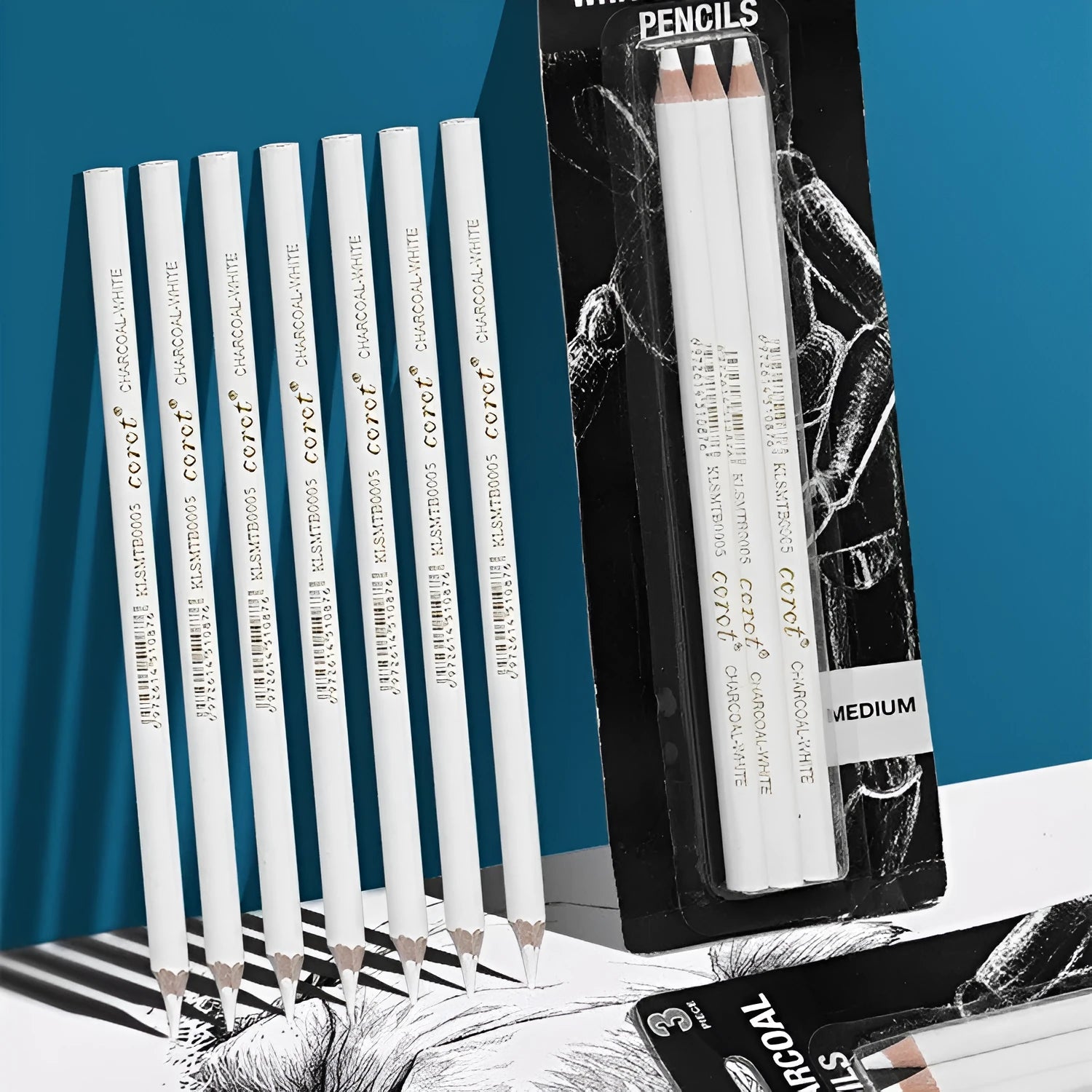 Three white charcoal pencils with wooden casings for drawing and highlighting