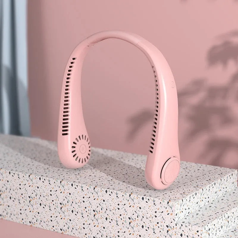 White bladeless neck fan being worn showing hands-free design and USB charging port