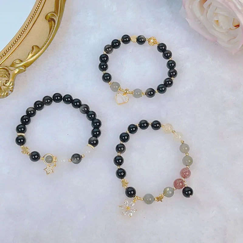 Silver stone bracelet with electroplated finish showing floral, love heart, and star charm designs