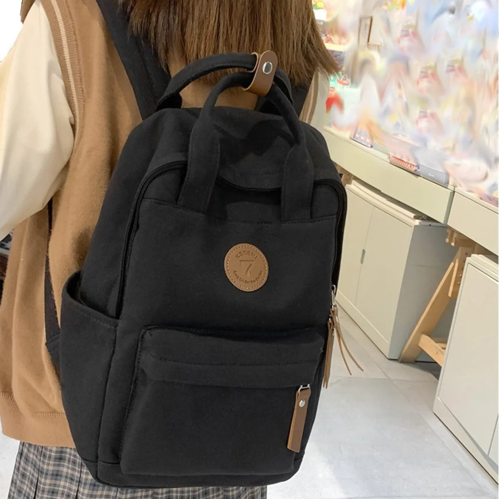 Black Oxford cloth leisure backpack with curved shoulder straps shown front view