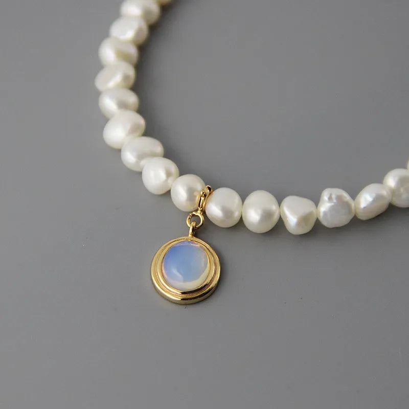 Silver necklace with geometric pendant and irregular pearls on adjustable chain
