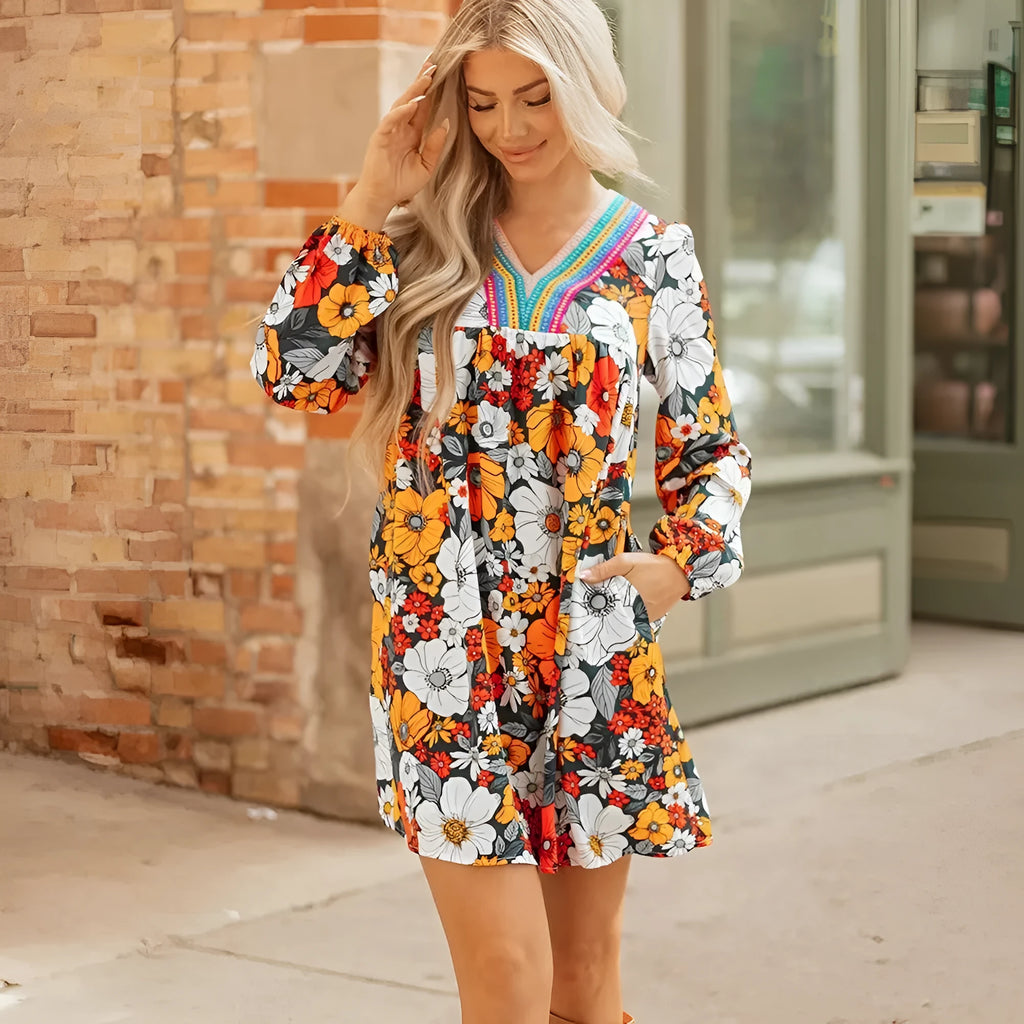 Orange floral print women's mini dress with striped lace detailing, V-neck, and long sleeves.