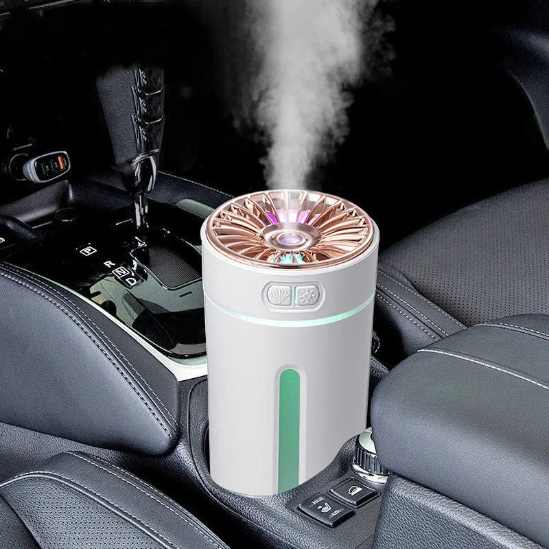 Black portable wireless ultrasonic humidifier with colourful LED lights on a car cup holder.