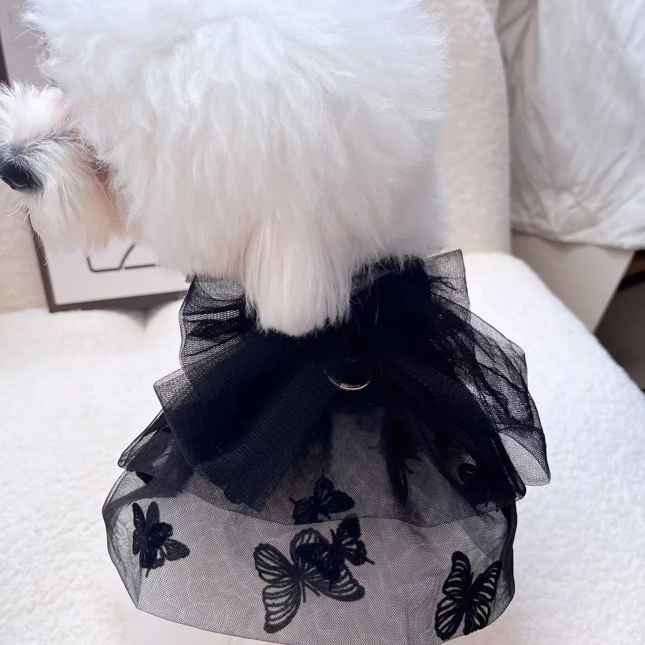 Black polyester tulle princess skirt for a small dog or cat on a hanger.