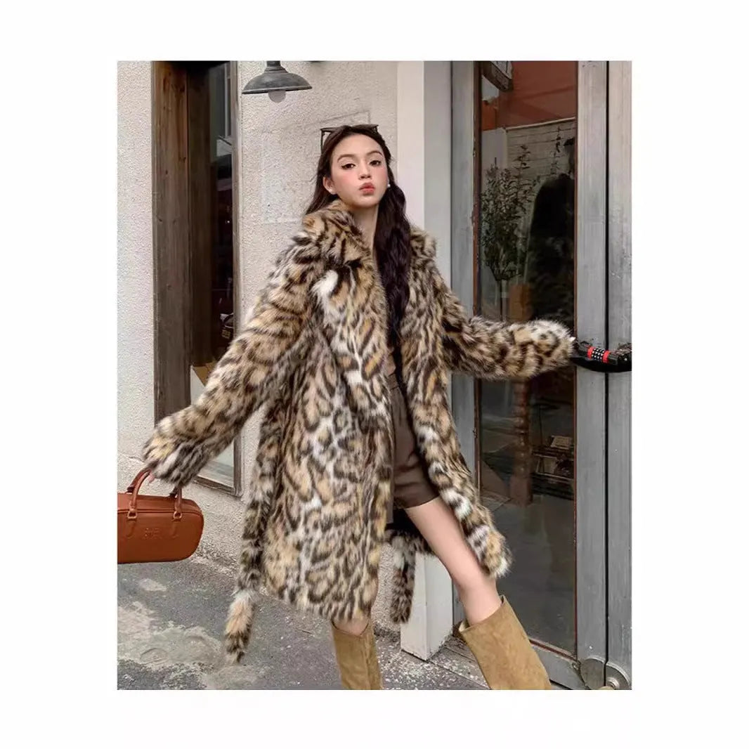 Women's grey faux fur mid-length winter coat with a fur collar and pockets on a model.