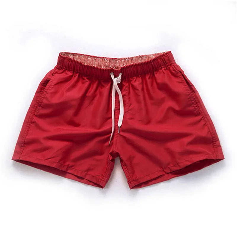 Men's plus-size polyester beach shorts in multiple colours on a size chart background.