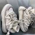 Women's grey retro clunky sneakers with a thick rubber sole and front lace-up closure on a white background.