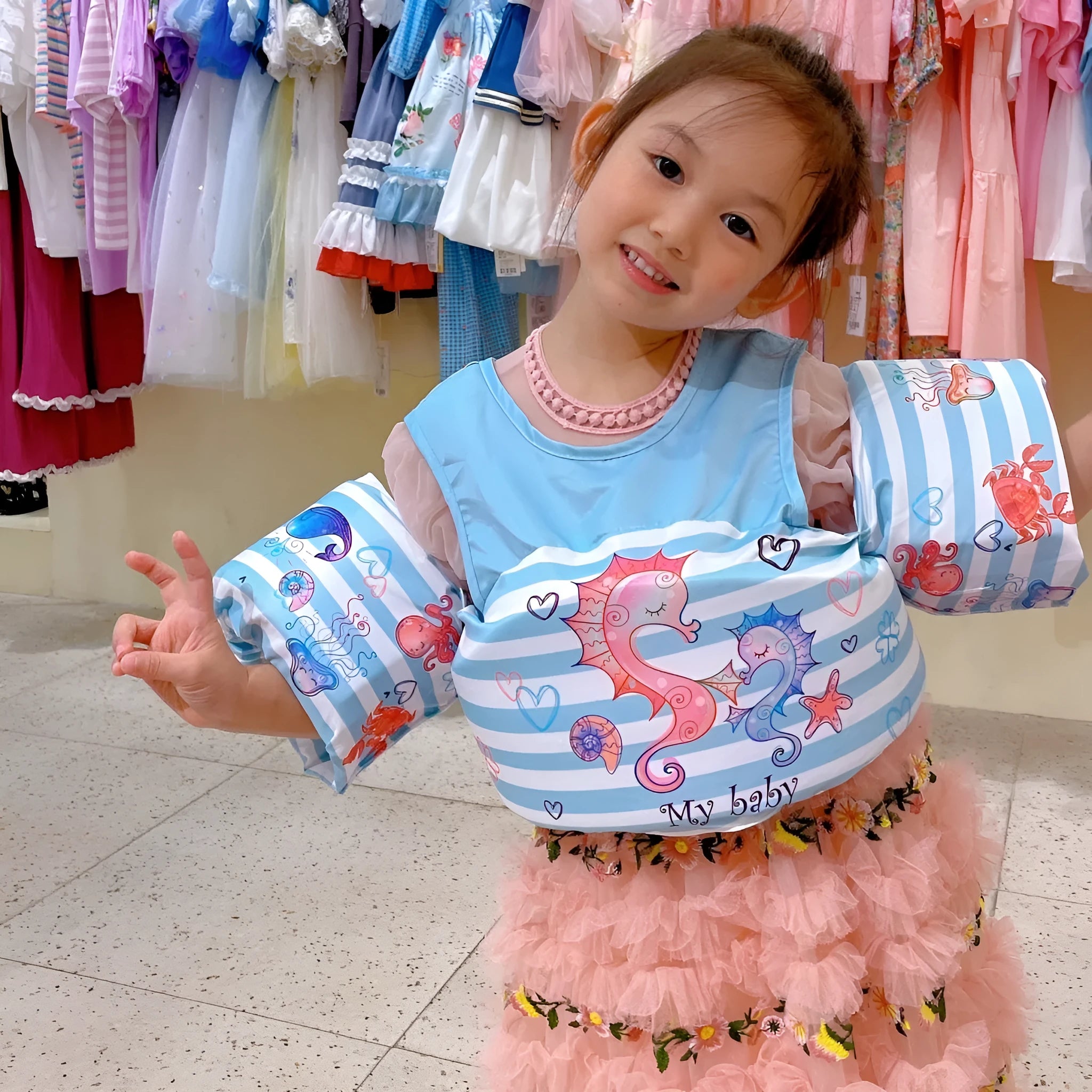 Children's swimsuit with extended arm swimming ring in colourful cartoon designs