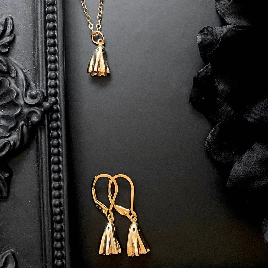 A ghost pendant necklace on a twisted stainless steel chain, showing the titanium steel electroplated pendant.