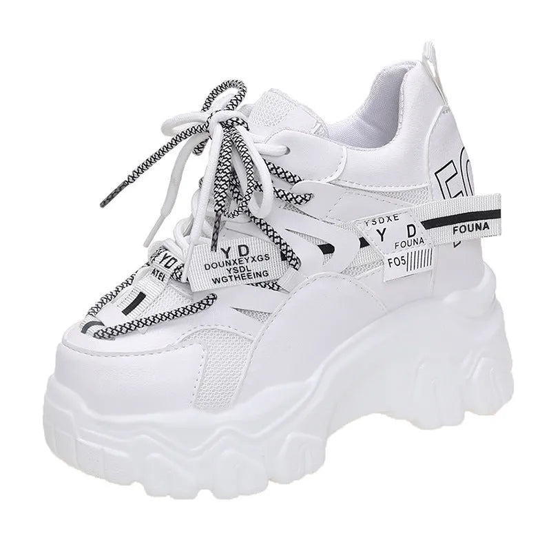 Women's white low-top platform tennis shoes with mesh upper and cross-strap detail on a rubber sole.