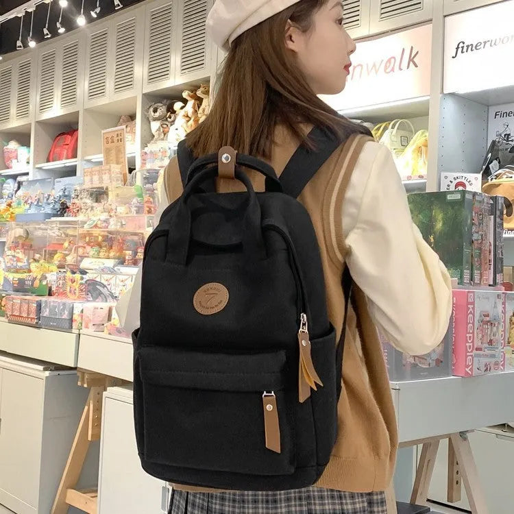 Black Oxford cloth leisure backpack with curved shoulder straps shown front view