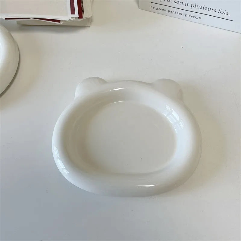 White ceramic plate with black hand-drawn doodle design, shown in bear and round patterns.