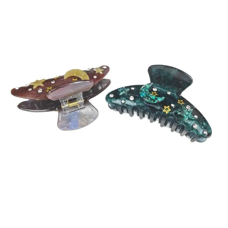 Oversized irregular-shaped barrette hair clip with a blue star moon starry sky celestial print.