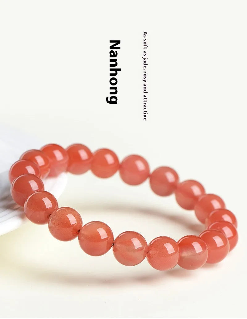 Natural cherry red agate scattered bead bracelet with polished stones on an adjustable strap.
