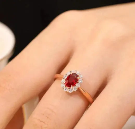 Sterling silver ring with gold pigeon design and red gemstone in floral pattern