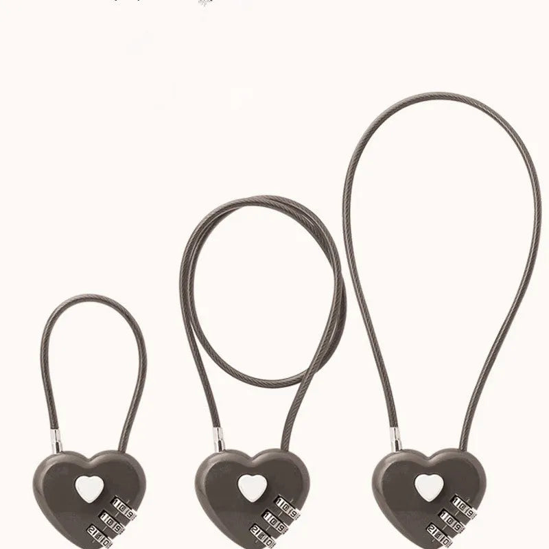 Peach heart-shaped cable lock with a long steel rope, shown in various colours including red, blue, and gold.